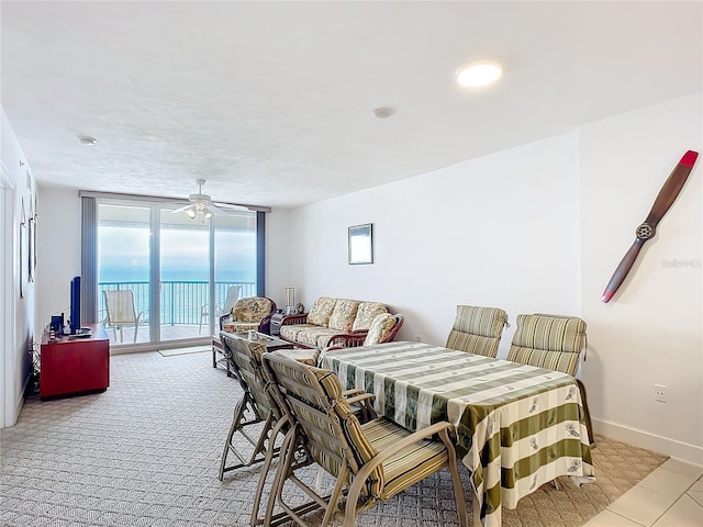 dining space with ceiling fan and floor to ceiling windows