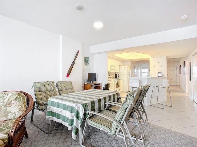 dining area featuring light tile patterned floors