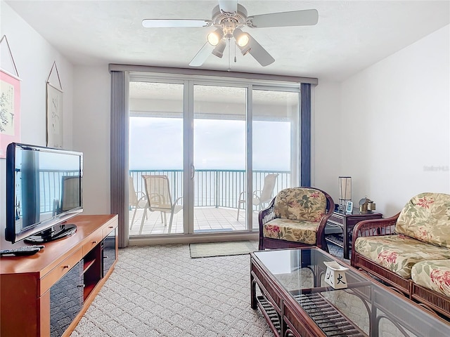 living room featuring carpet floors, a healthy amount of sunlight, and ceiling fan