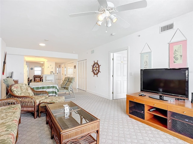 carpeted living room with ceiling fan