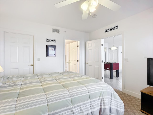 carpeted bedroom featuring ceiling fan and a closet