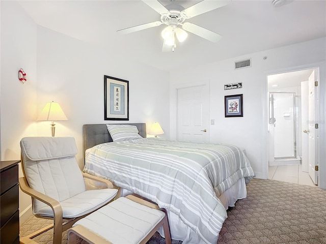 carpeted bedroom featuring ceiling fan and ensuite bath