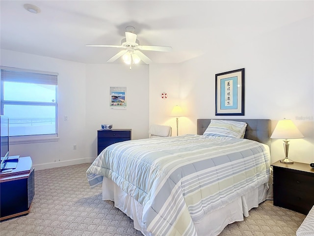 bedroom with ceiling fan and light colored carpet