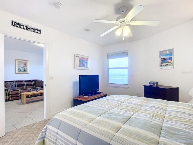 tiled bedroom featuring ceiling fan