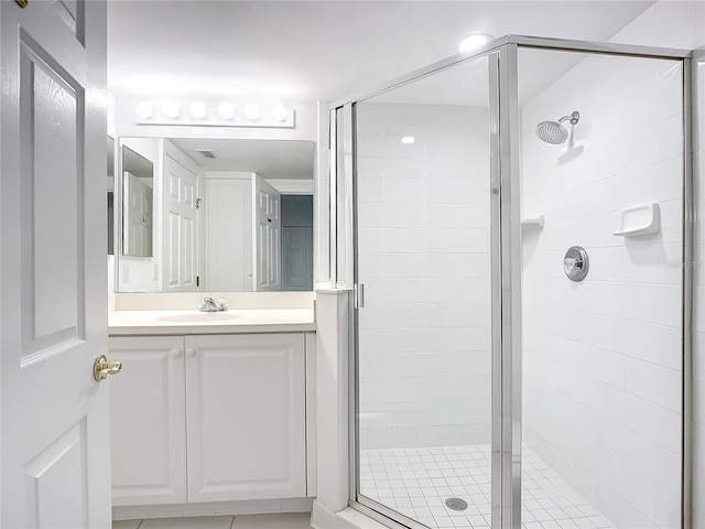 bathroom featuring walk in shower and vanity