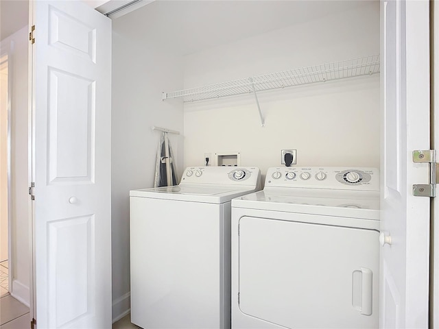 laundry area featuring washer and clothes dryer and tile patterned flooring