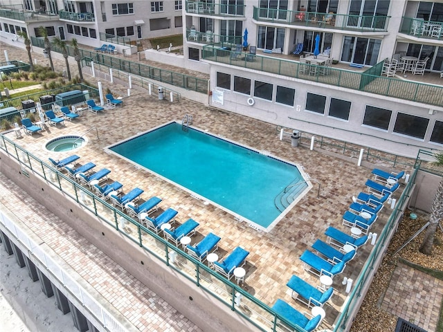 view of pool featuring a community hot tub and a patio