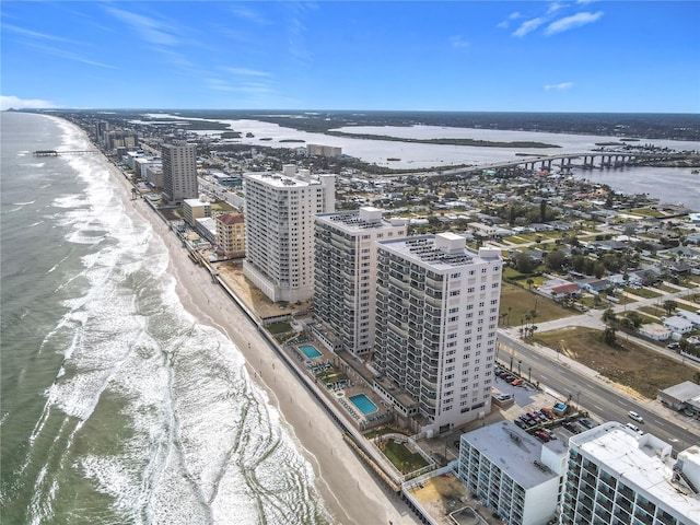 birds eye view of property with a view of the beach and a water view