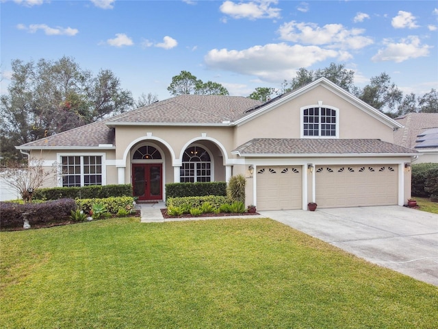 view of front of house with a front yard and a garage