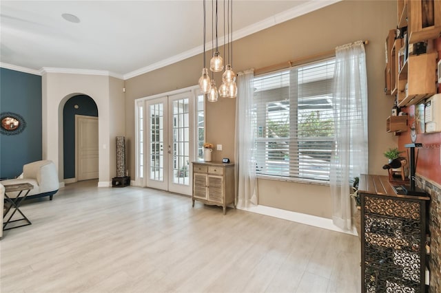 sitting room featuring french doors, a chandelier, hardwood / wood-style floors, and crown molding