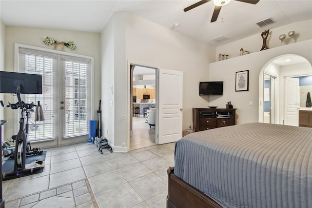 bedroom featuring connected bathroom, light tile patterned floors, ceiling fan, access to exterior, and lofted ceiling