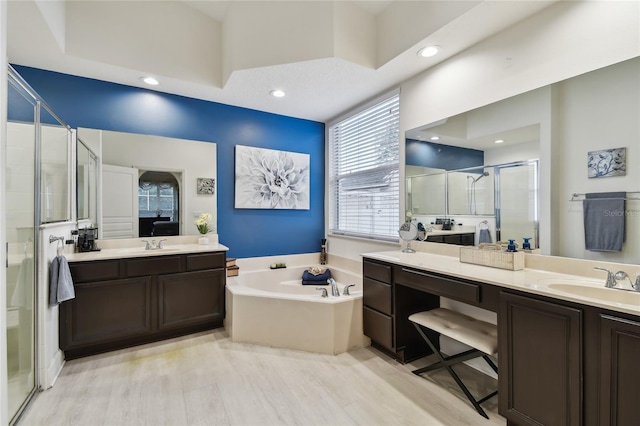 bathroom featuring separate shower and tub, wood-type flooring, and vanity