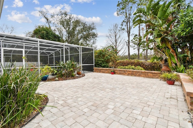 view of patio / terrace featuring glass enclosure