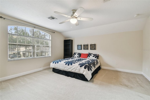 bedroom with lofted ceiling, ceiling fan, and carpet