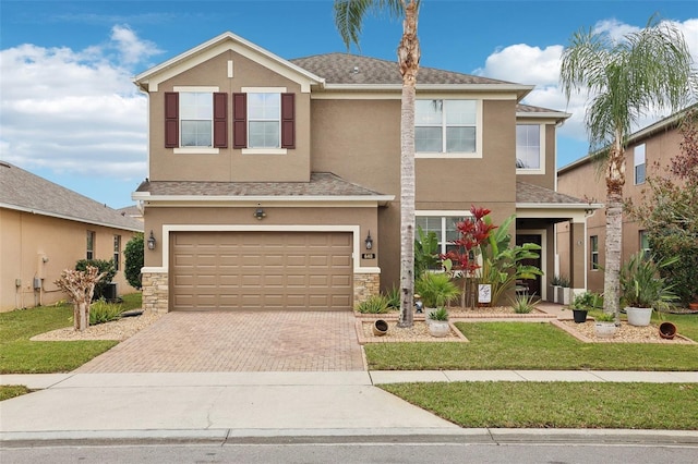 view of front facade featuring a front lawn and a garage