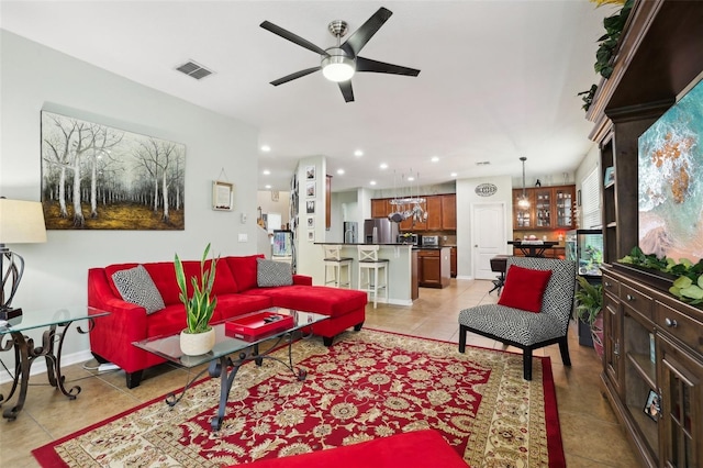 living room featuring ceiling fan and light tile patterned flooring