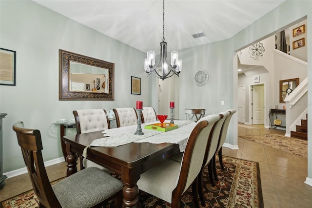 dining area featuring tile patterned flooring and a notable chandelier