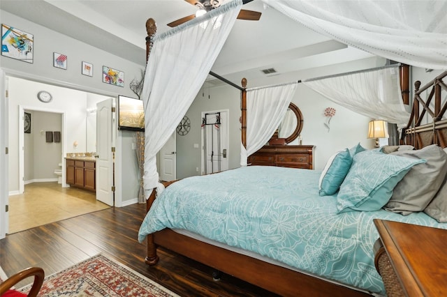 bedroom featuring hardwood / wood-style floors, ensuite bath, and ceiling fan