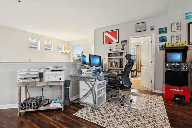 office with dark hardwood / wood-style flooring and a chandelier