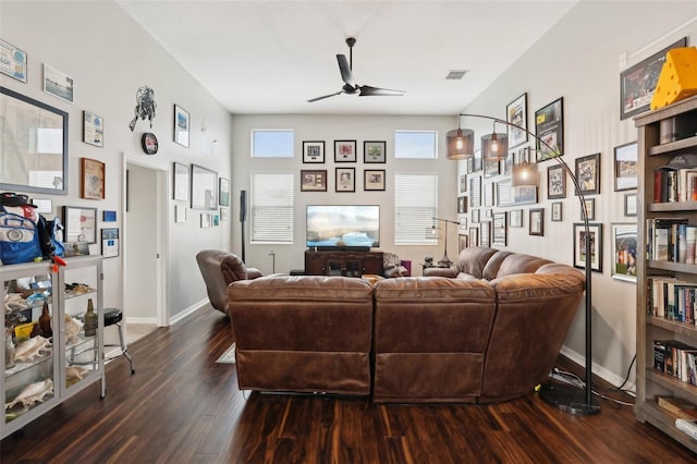 living room with ceiling fan and dark hardwood / wood-style flooring