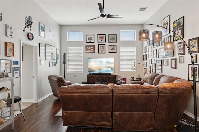 living room featuring dark hardwood / wood-style floors and ceiling fan