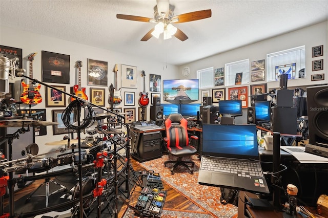 interior space with ceiling fan and a textured ceiling