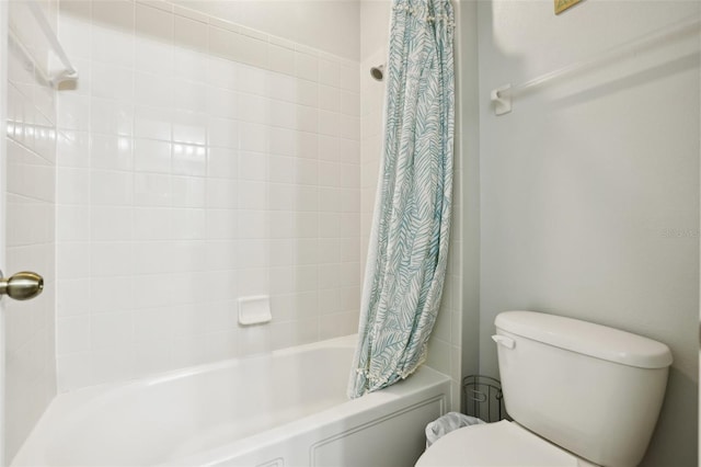 bathroom featuring shower / tub combo and toilet