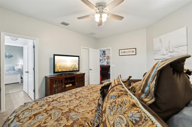 bedroom with ensuite bathroom, ceiling fan, and light tile patterned floors