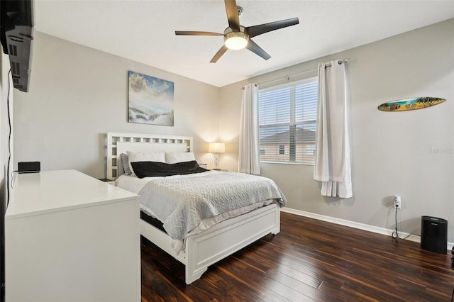 bedroom with ceiling fan and dark hardwood / wood-style floors