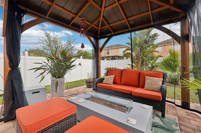 view of patio / terrace featuring a gazebo and an outdoor living space with a fire pit