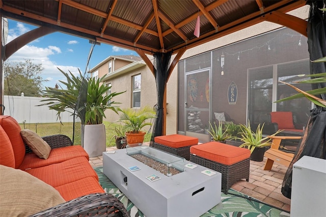 view of patio with a fire pit and a gazebo