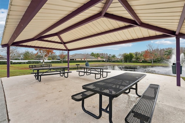 view of home's community with a gazebo, a water view, and a lawn