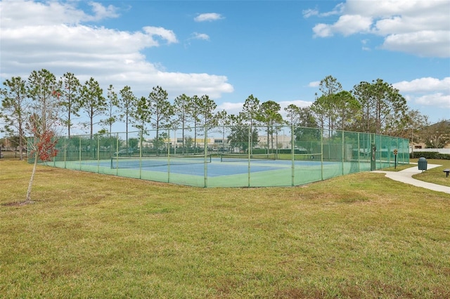 view of sport court with a lawn