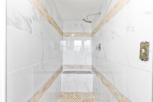 bathroom with tiled shower