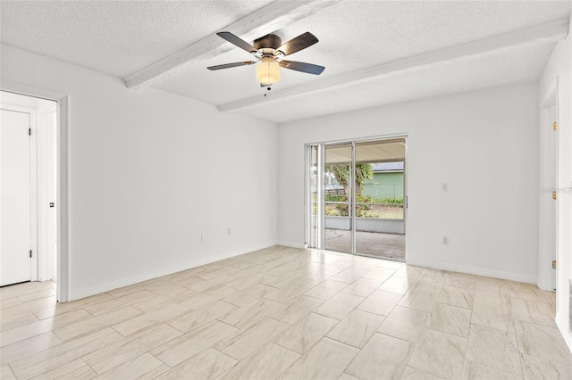 empty room with a ceiling fan, beamed ceiling, a textured ceiling, and baseboards