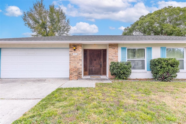 single story home featuring concrete driveway, stucco siding, an attached garage, a front yard, and brick siding