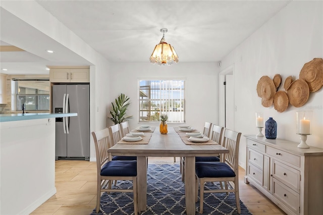 dining room featuring recessed lighting, a notable chandelier, and light wood-style flooring