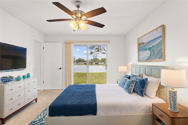 bedroom featuring light carpet, a ceiling fan, and access to exterior