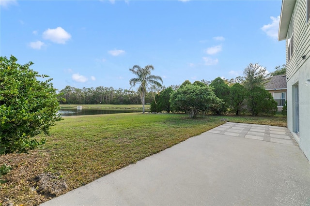 view of yard featuring a patio and a water view