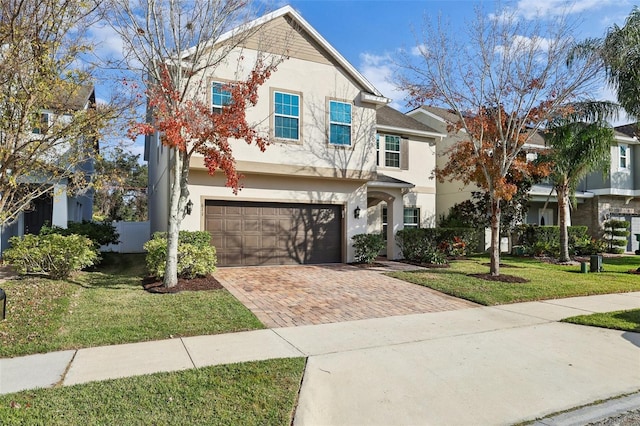 view of front of property with a garage and a front lawn