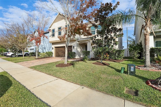 view of front of property with a garage and a front yard