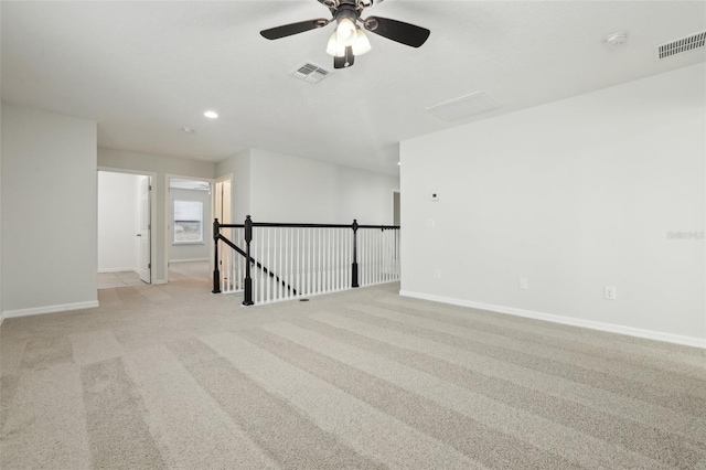 unfurnished room with ceiling fan and light colored carpet