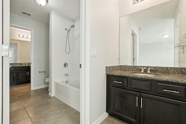 full bathroom featuring tile patterned floors, vanity, toilet, and tiled shower / bath