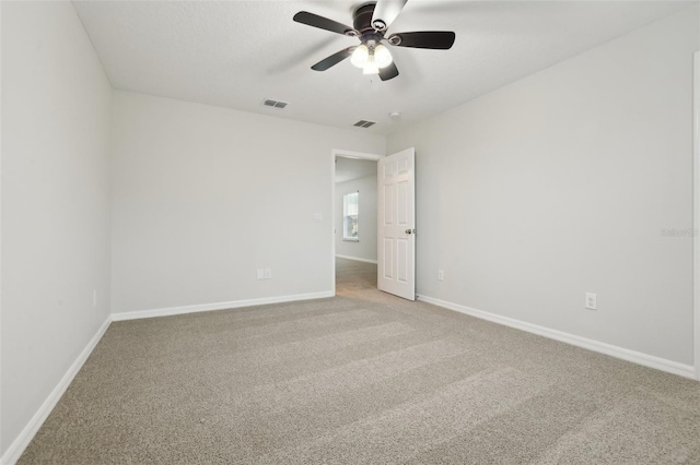 empty room featuring carpet flooring and ceiling fan