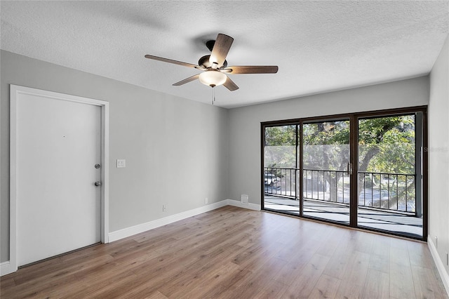 unfurnished room with a textured ceiling, light hardwood / wood-style flooring, and ceiling fan