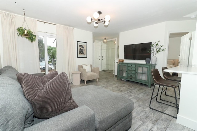 living room with an inviting chandelier and light wood-type flooring