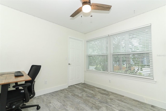 home office featuring ceiling fan and light hardwood / wood-style flooring