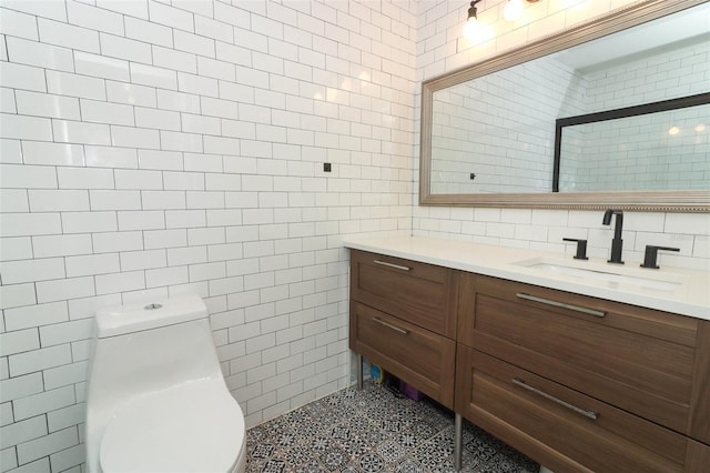 bathroom with tile patterned floors, walk in shower, vanity, tile walls, and toilet