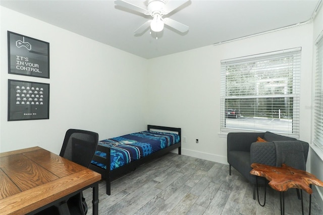 bedroom with hardwood / wood-style floors and ceiling fan