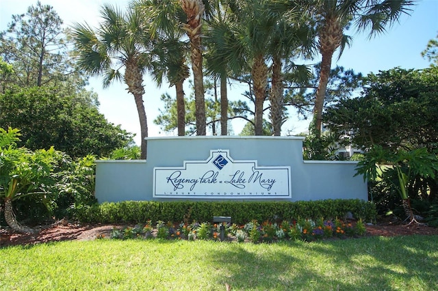 community / neighborhood sign with a lawn